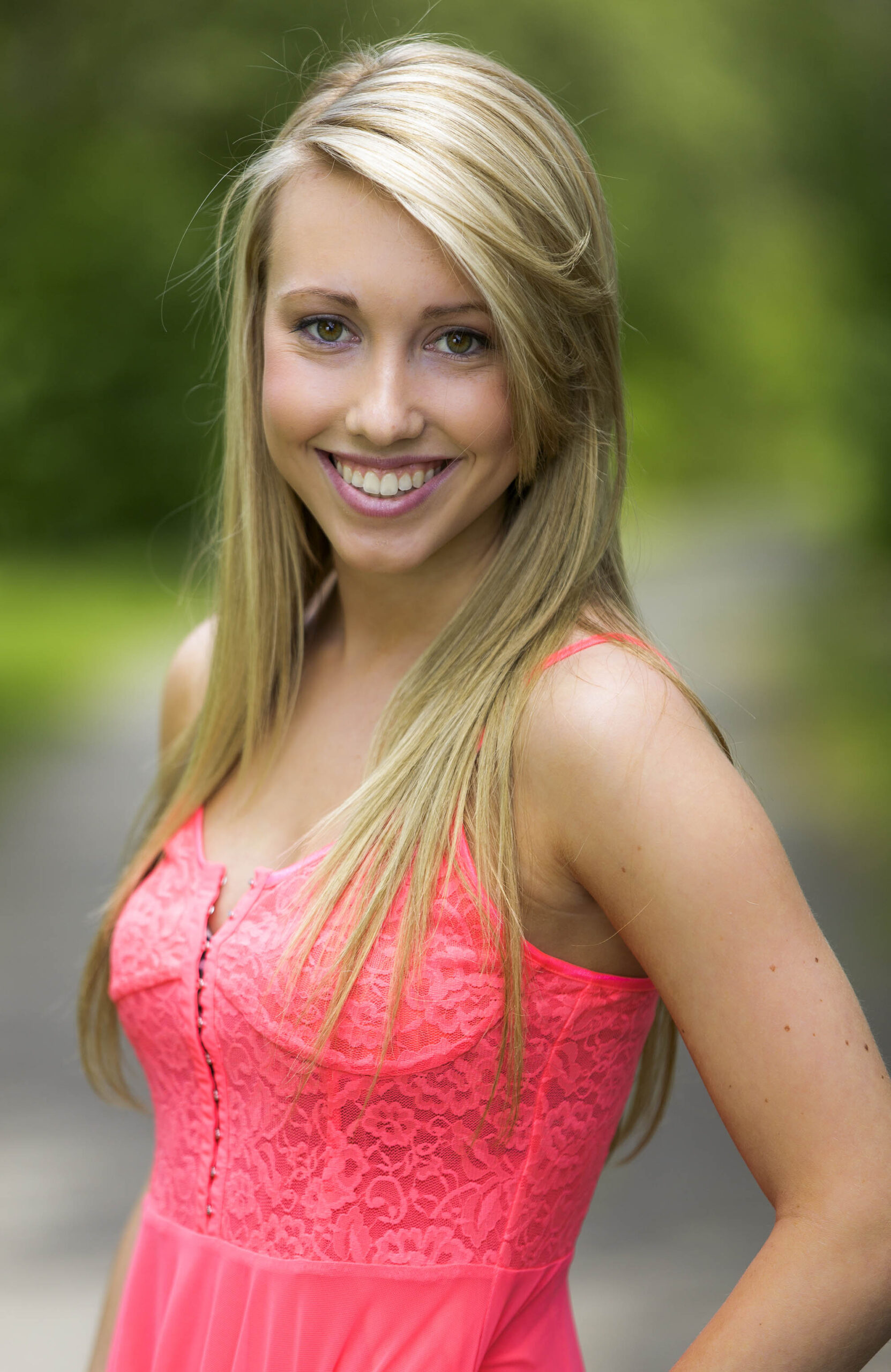 Young happy teen portrait smiling in a pink dress