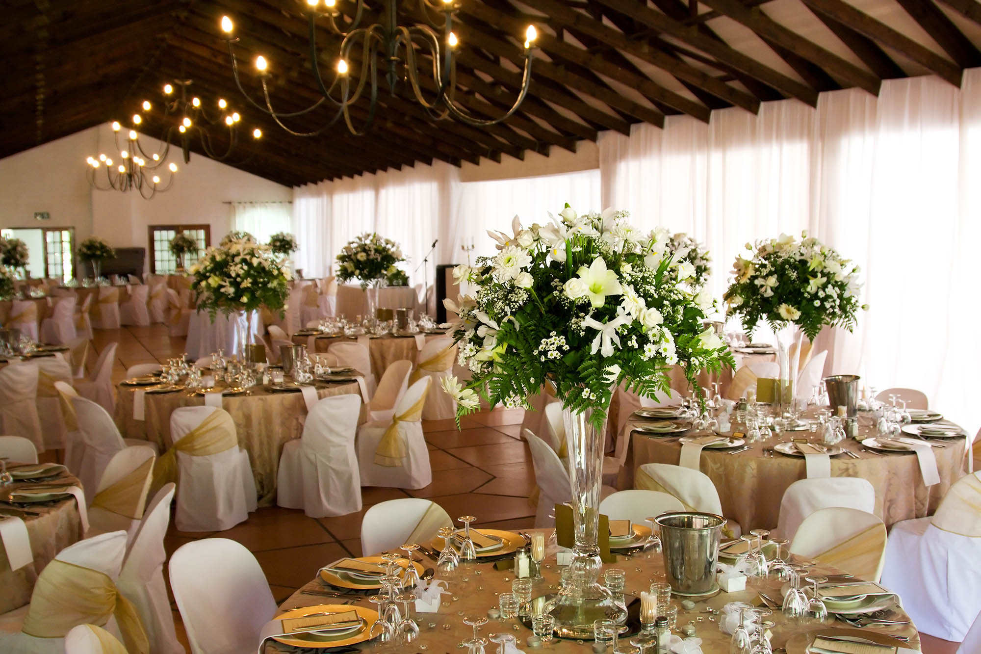 Indoors wedding reception venue with dÃ©cor, selective focus on flowers
